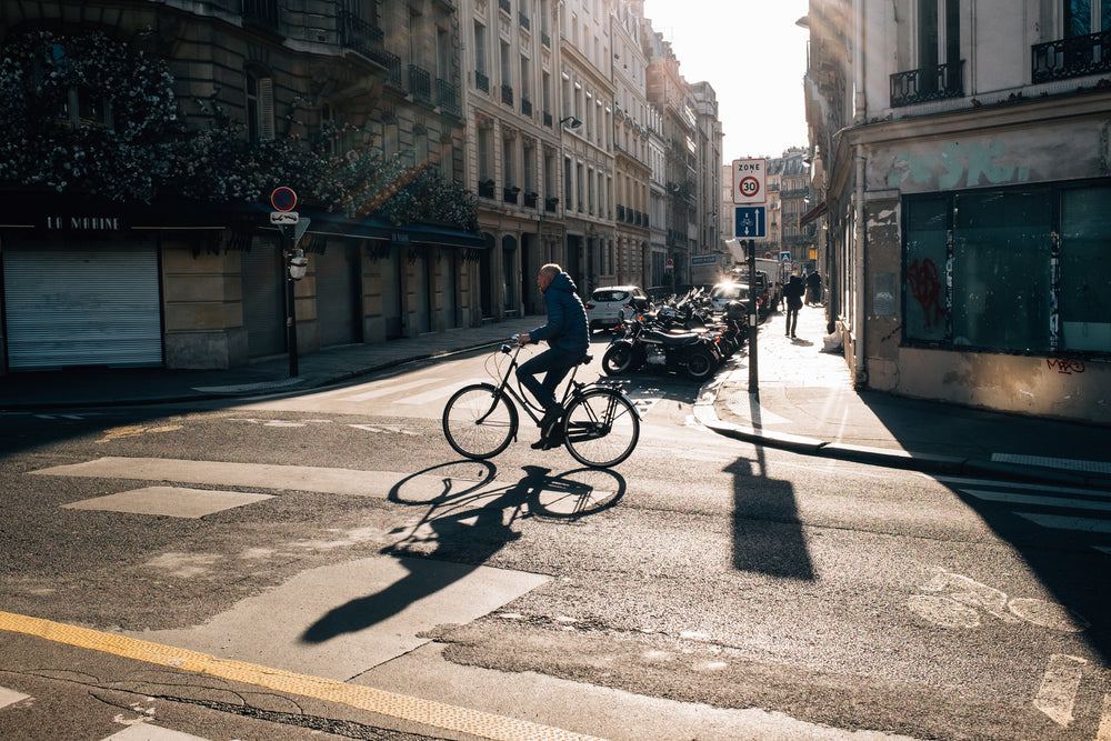 someone riding their bike on a quiet city street