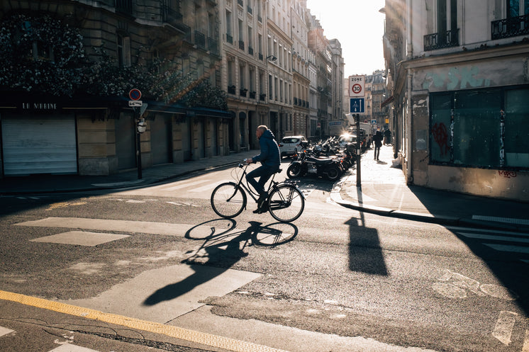 Someone Riding Their Bike On A Quiet City Street