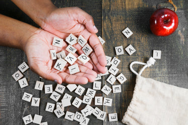 spelling game letter tiles in hand