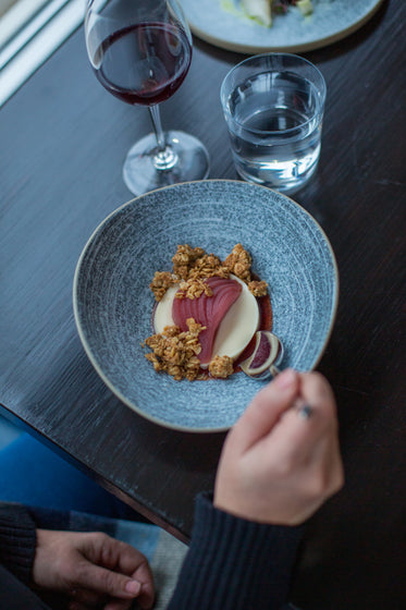 spoon dips into a beautifully plated meal