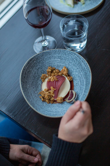 spoon dips into a beautifully plated meal