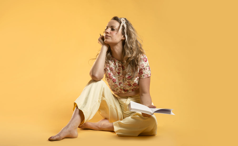 spring fashion model sitting and holding notebook