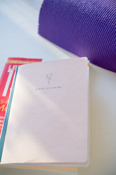 stack of books and a yoga mat