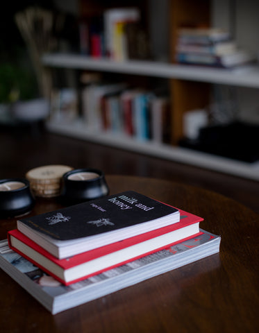 stack of books and candles on a lounge coffee table