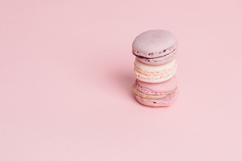 stack of pink macarons on pink right side
