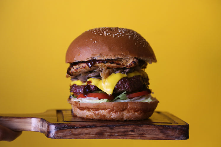 stacked-cheeseburger-on-yellow-backgroun