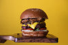 Stacked Cheeseburger On Yellow Background