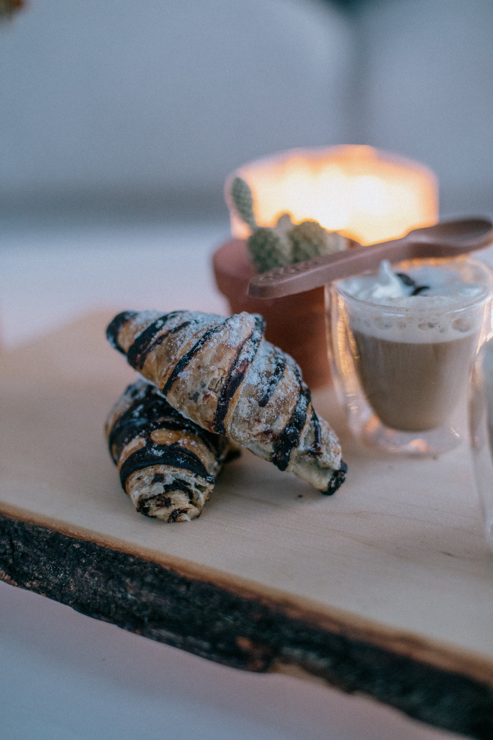 Stacked Chocolate Croissants On A Wooden Board