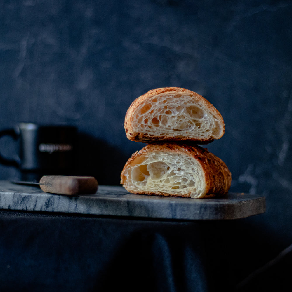 stacked croissant sliced in half showing fluffy pastry