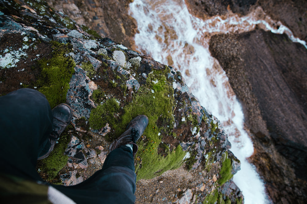 standing at waterfalls edge