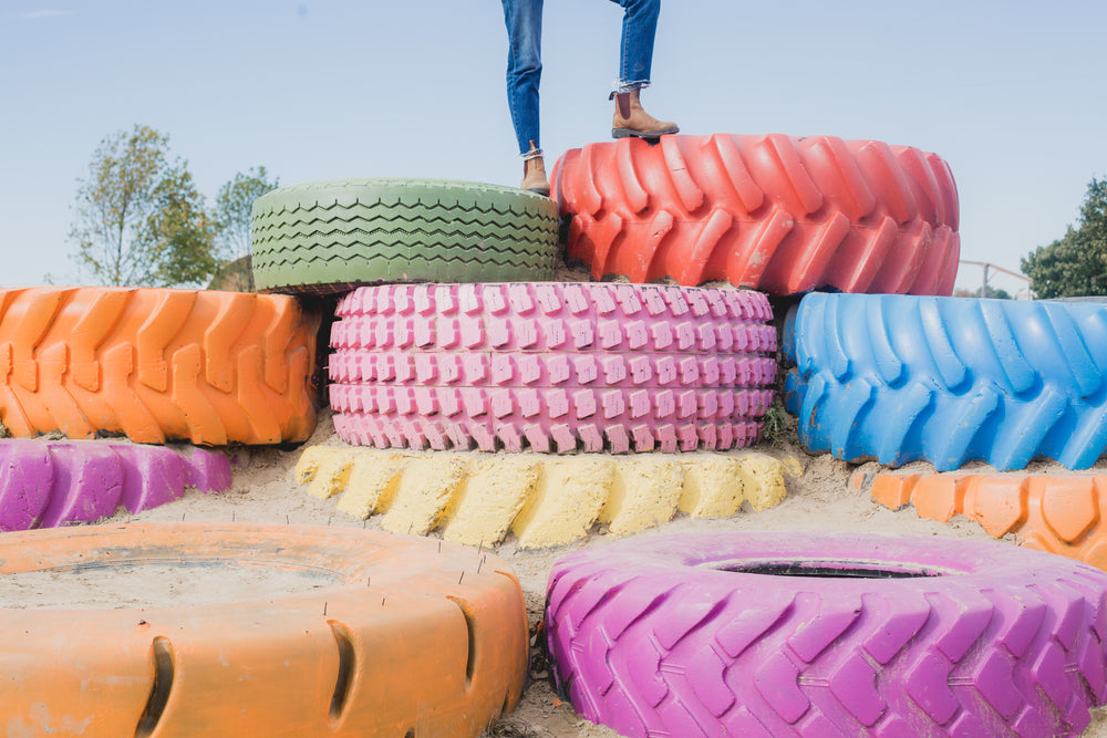 standing on colorful painted tires