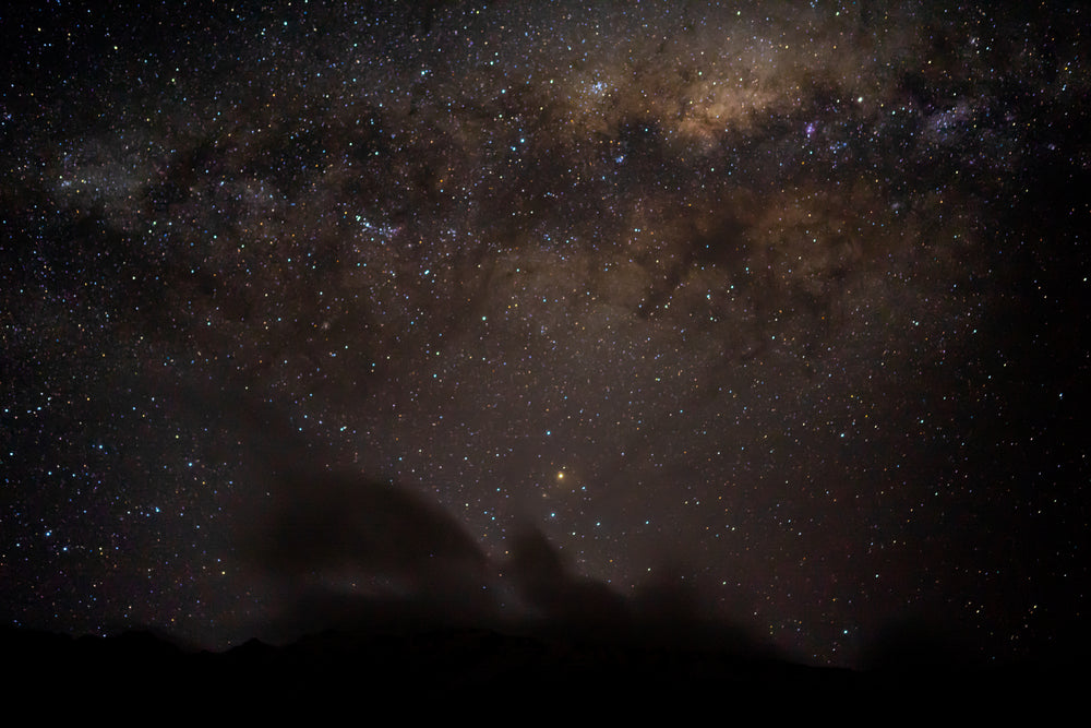 starry night above with clouds below