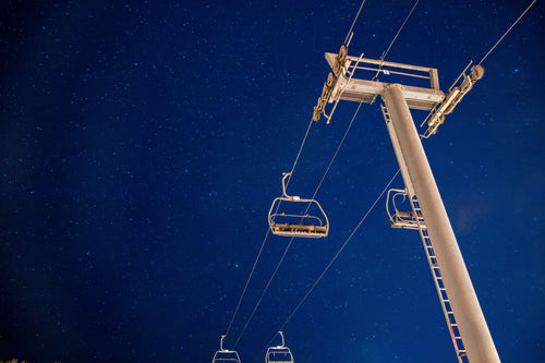 starry night sky and a chairlift