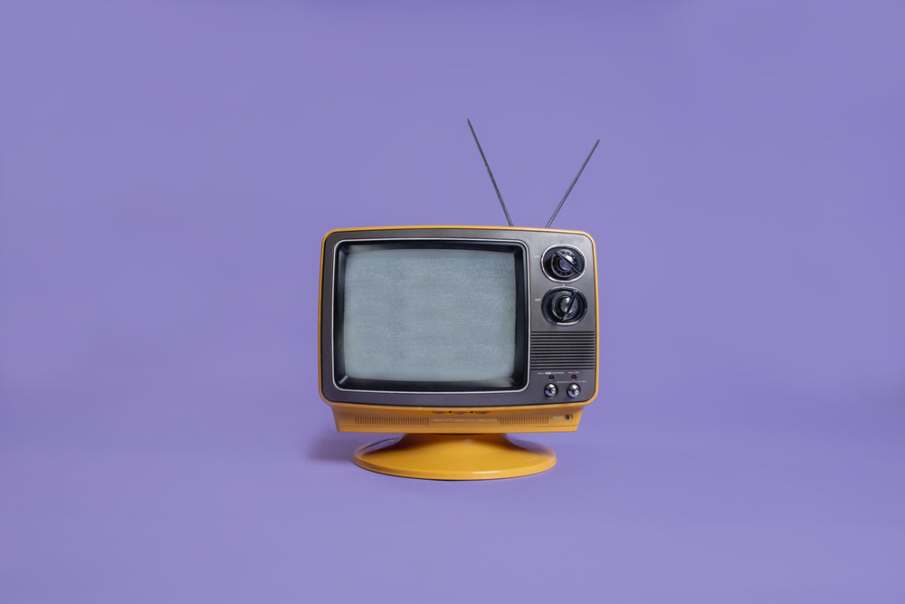 static on a plastic tv on purple background