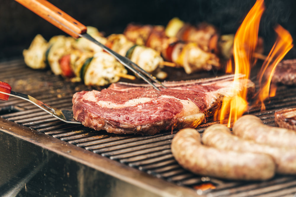 steak and flames on the grill