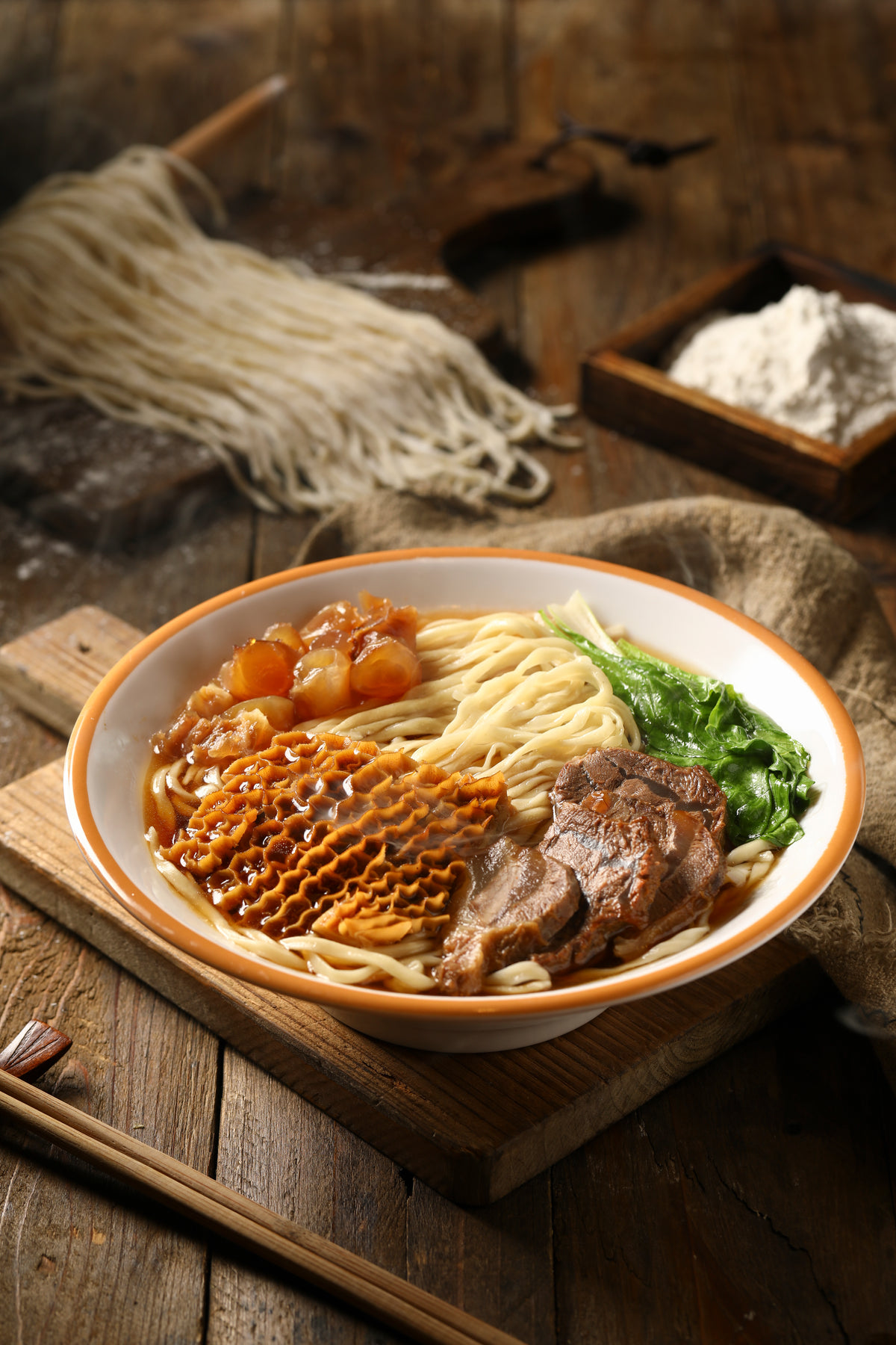 Steaming Bowl Of Noodle Soup On A Wooden Surface