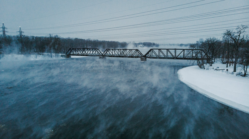 steaming winter water under train bridge