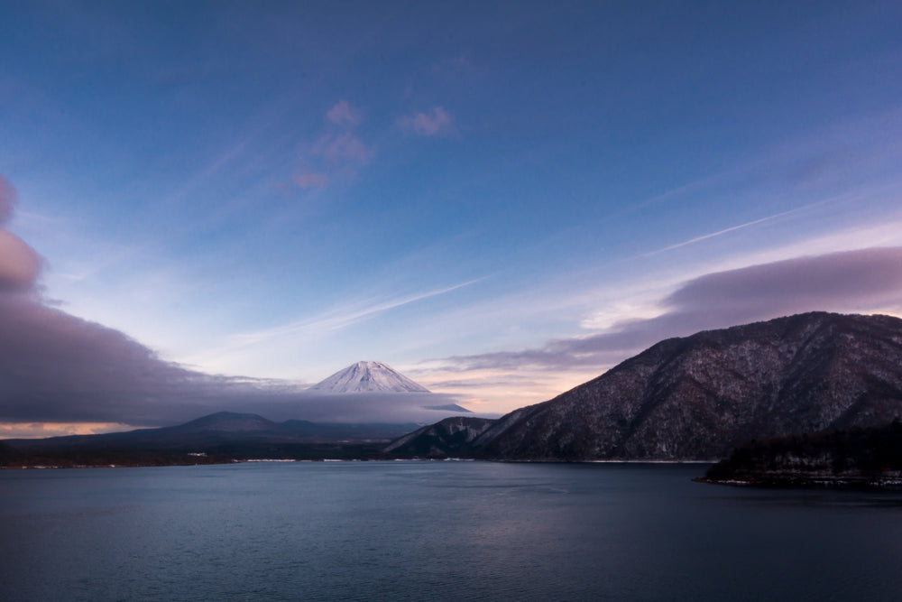 still blue lake with a snow capped mountain