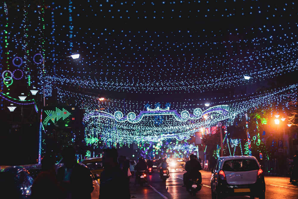 sting lights hanging over a busy city road