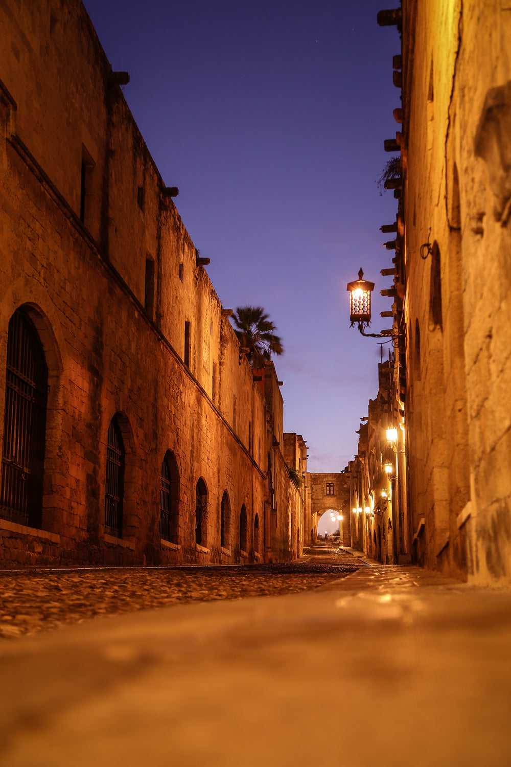 stone alleyway illuminated at night time