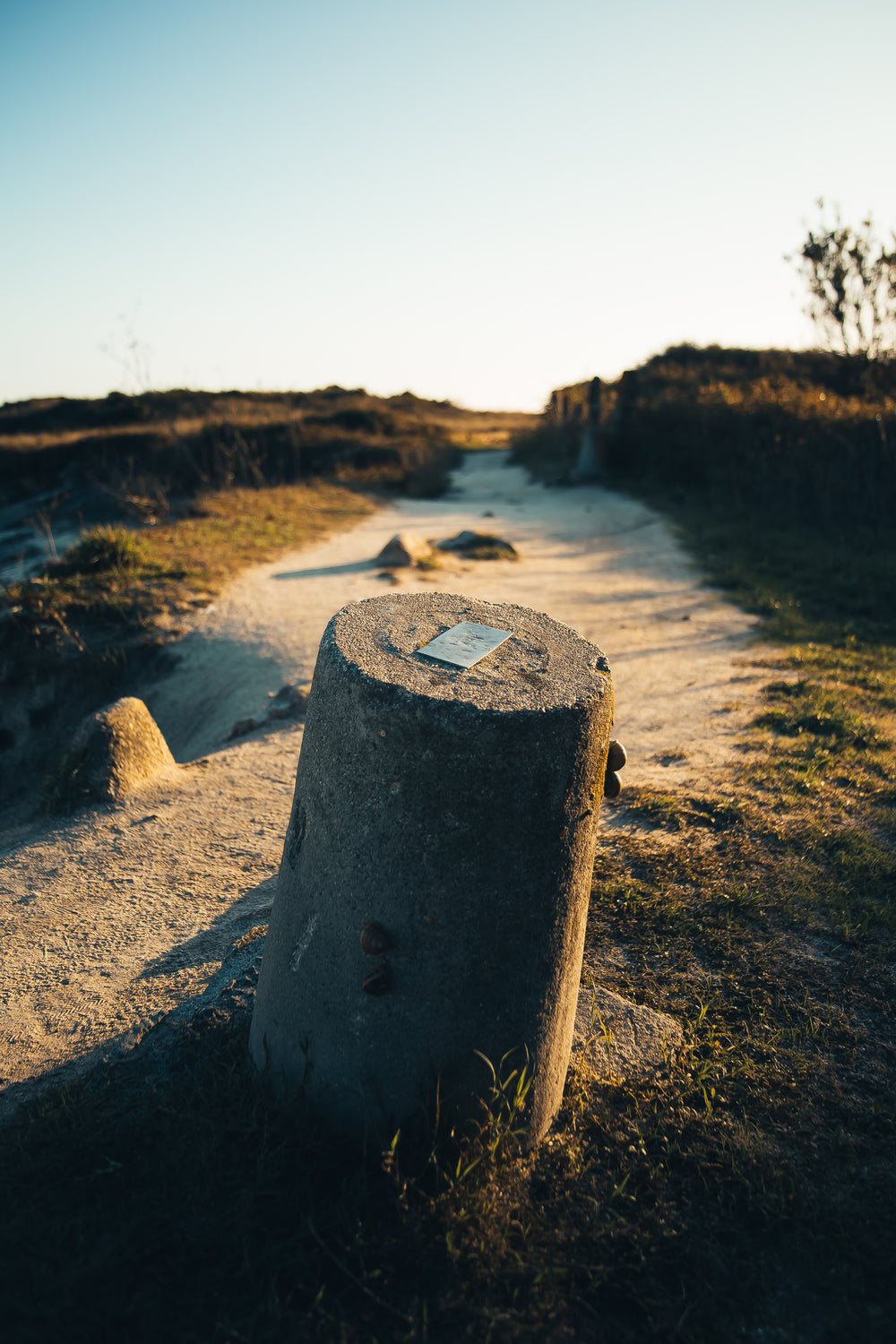 stone bollard in sand