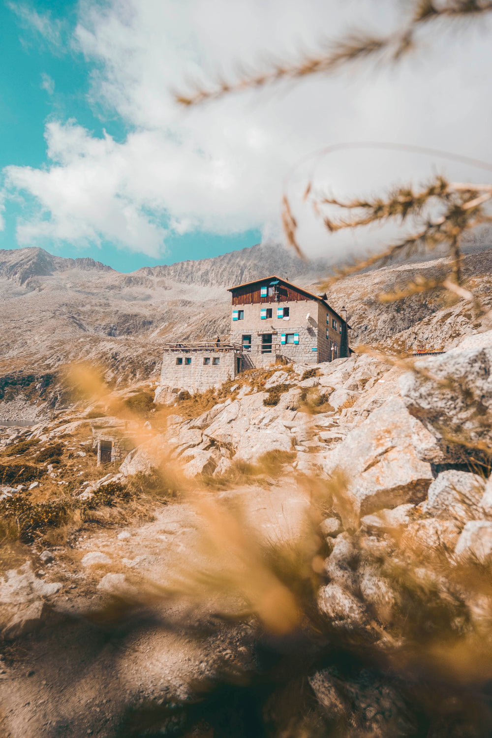 stone building sits within a mountain range