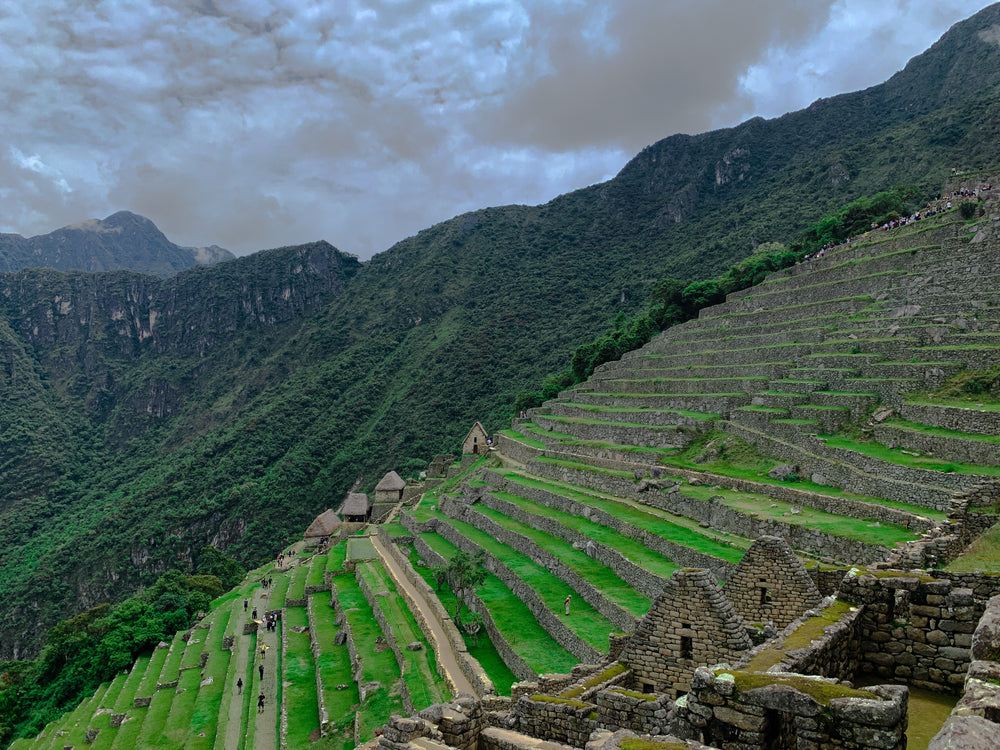 stone buildings and steps beide a lush green hill