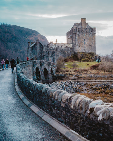 stone castle on a hill below a cloudy