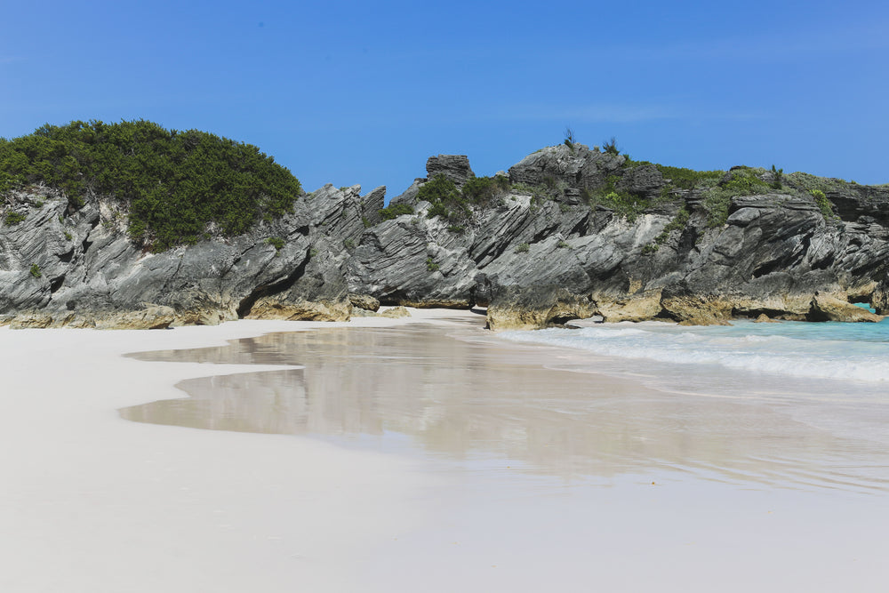 stone shoreline frames sky