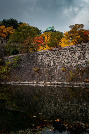 stone wall with water surrounded by water and trees