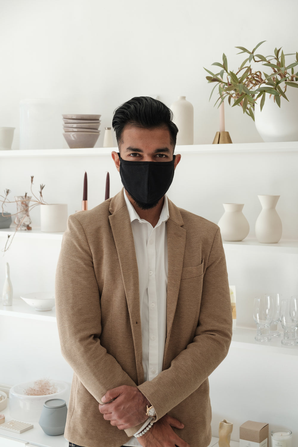 store owner poses in front of his merchandise