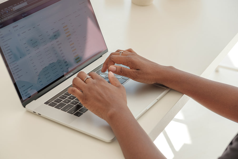 store owners hands typing away