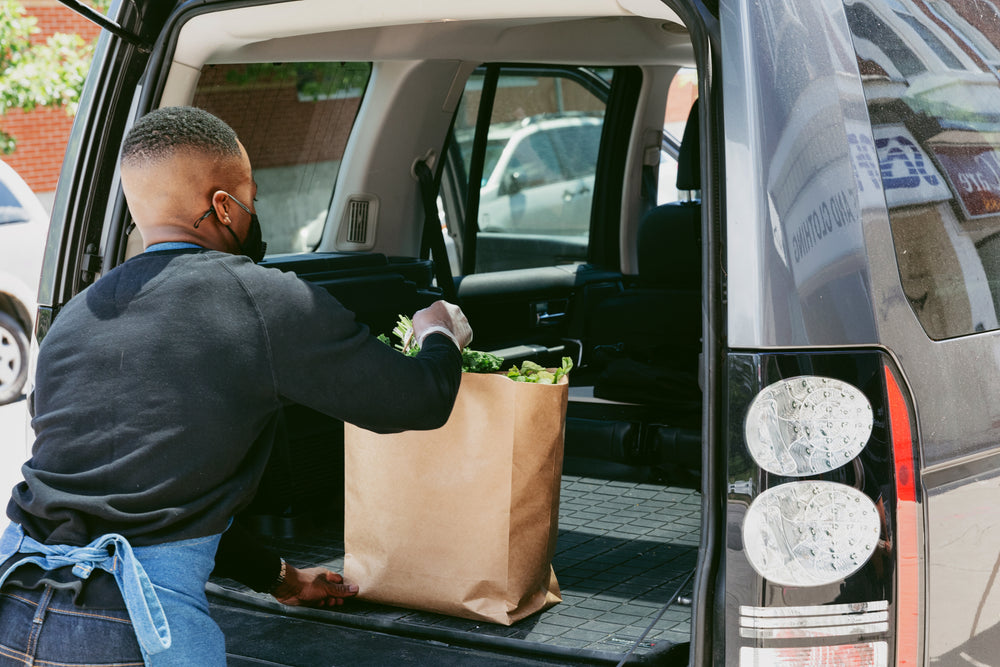 store staff places customer order in back of car