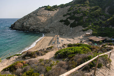 straw parasols on a beach in greece