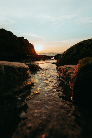 stream meets the sea at sunset