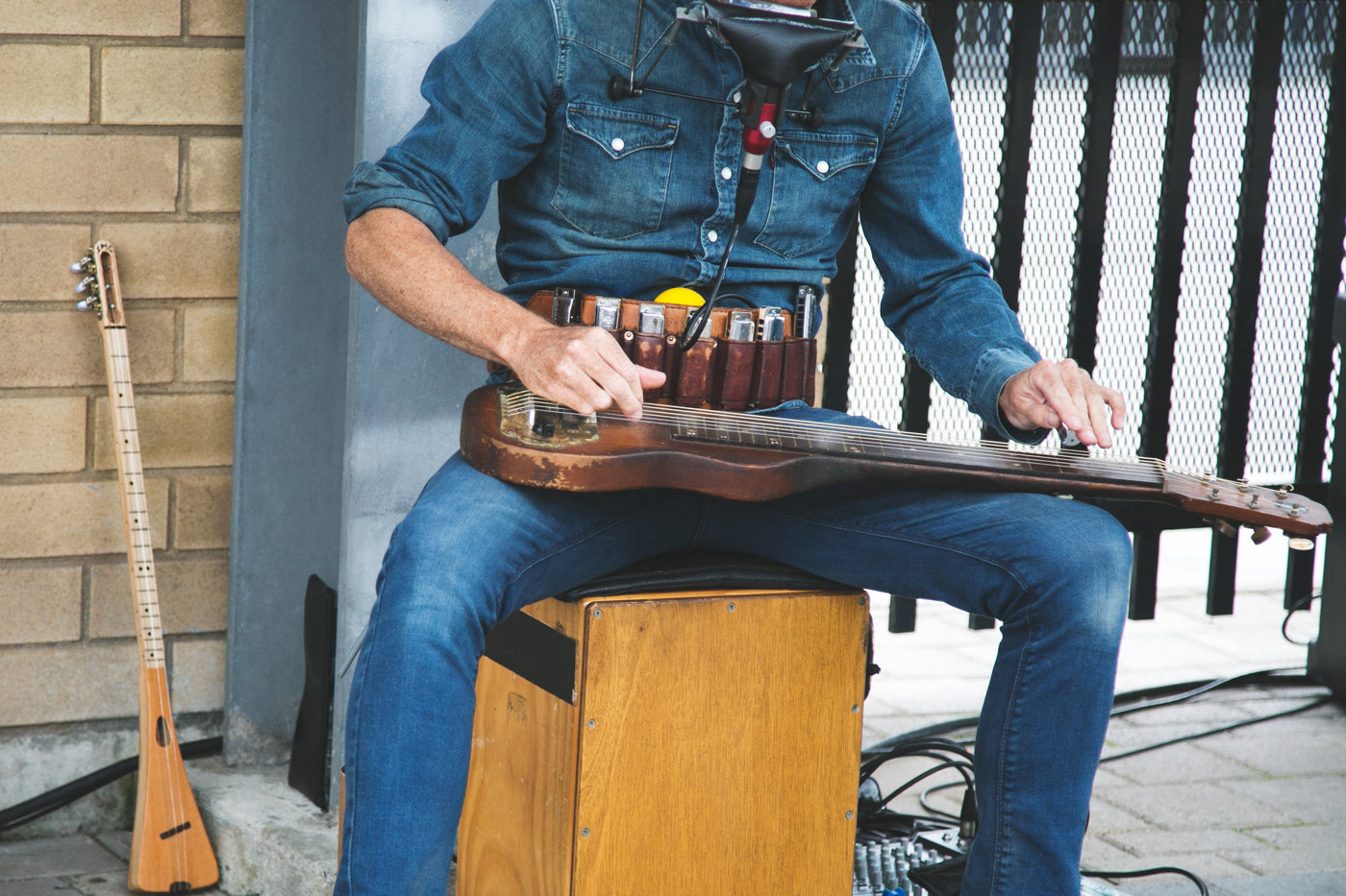 A street performer playing guitar on a corner
