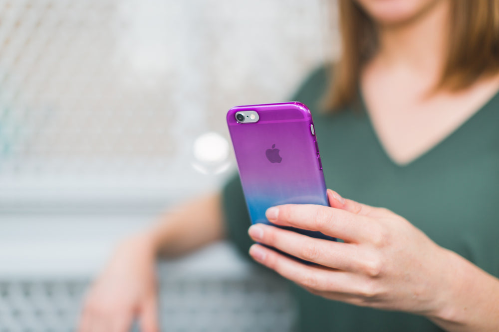 student holding iphone