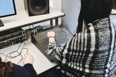 students learn on sound mixing board