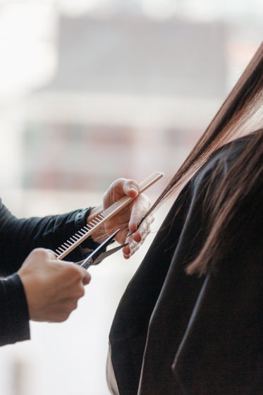 stylist cuts long hair