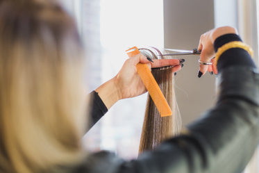 stylist cutting long hair