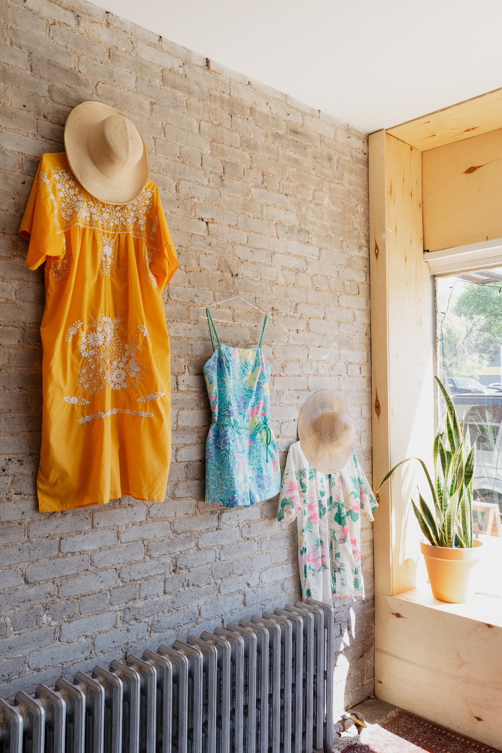 summer outfits displayed on exposed wall in store