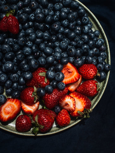 summer strawberries and blueberries on blue linen cloth