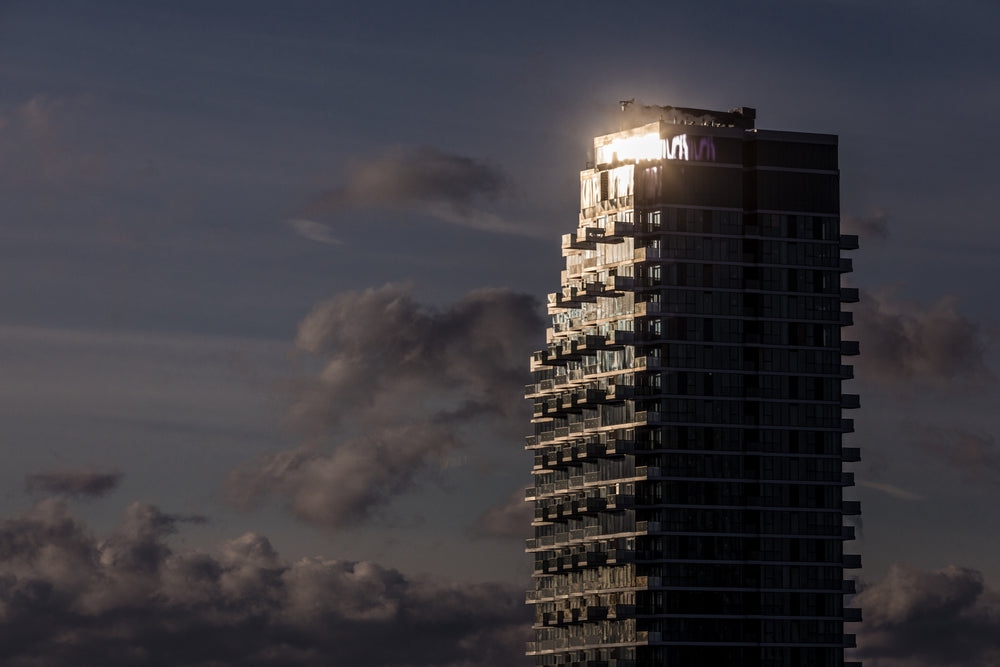 sun glinting off top of condo tower