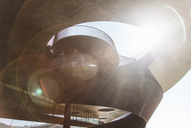 sun rays through a spiraled stair case