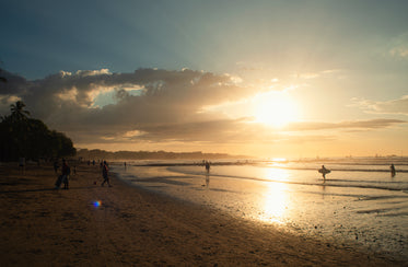 sun sets in the distance and shines on the water