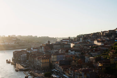 sun sets in the distance creating shadows on roofs