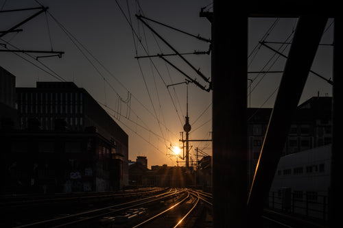 sun sets over empty train tracks