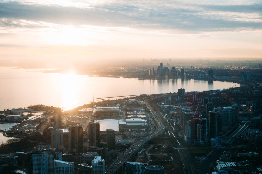 sun sets over west toronto skyline