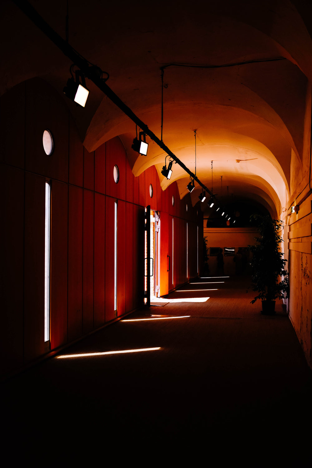 sunlight slices through narrow windows into a dark corridor
