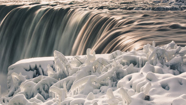 sunlit waterfalls and ice covered branches